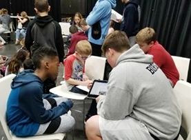 photo of students collaborating on a story 